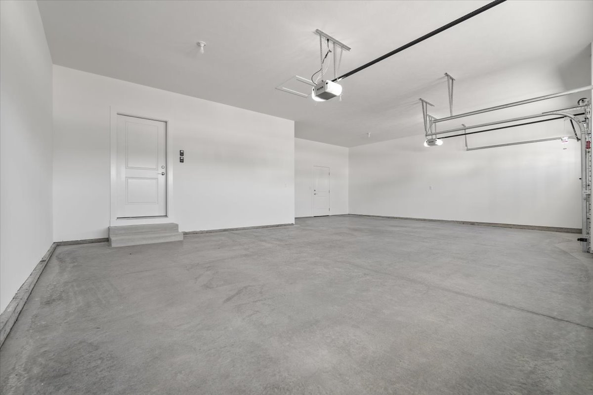 24 Stonehouse Court Bloomington, IL 61705 - Photo 5 of 45 an empty room with ceiling fan and windows