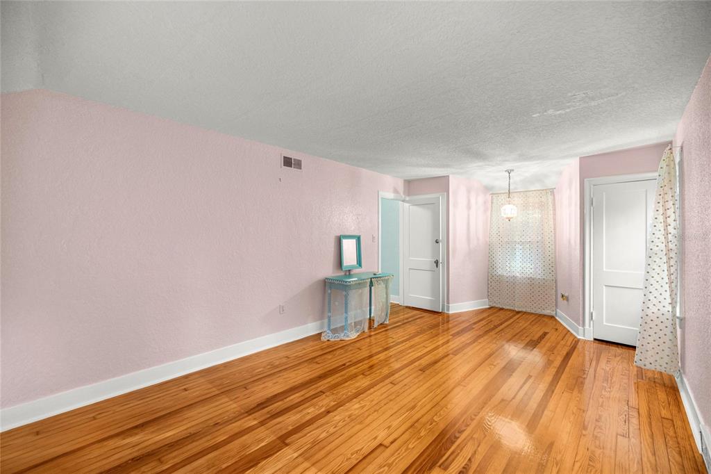 1226 Southeast 9th Avenue Ocala, FL 34471 - Photo 34 of 49 a bedroom with a bed and wooden floor