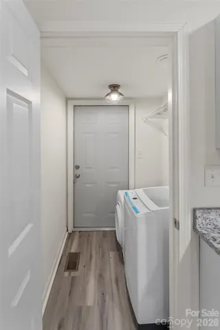 a hallway with a washer and dryer