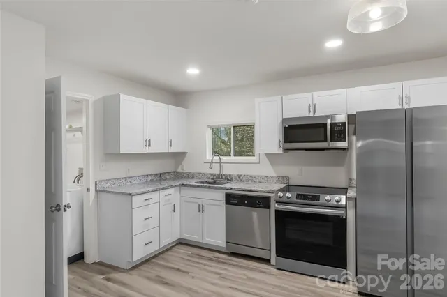 a kitchen with a sink stove and microwave