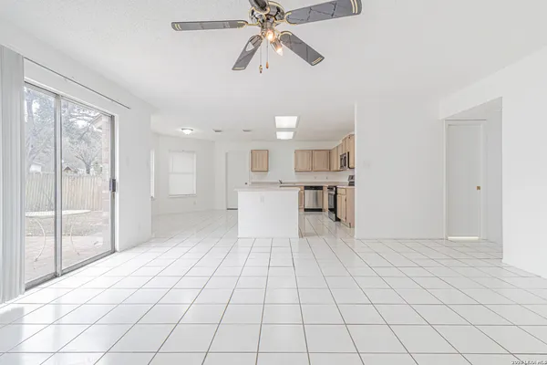 a view of a kitchen with furniture and a chandelier fan