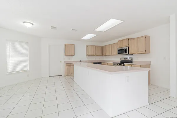 a kitchen with stainless steel appliances a refrigerator sink and cabinets