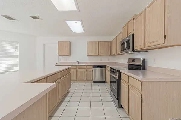 a kitchen with stainless steel appliances granite countertop a sink and cabinets