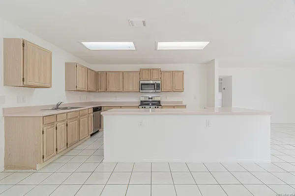 a kitchen with cabinets and white appliances