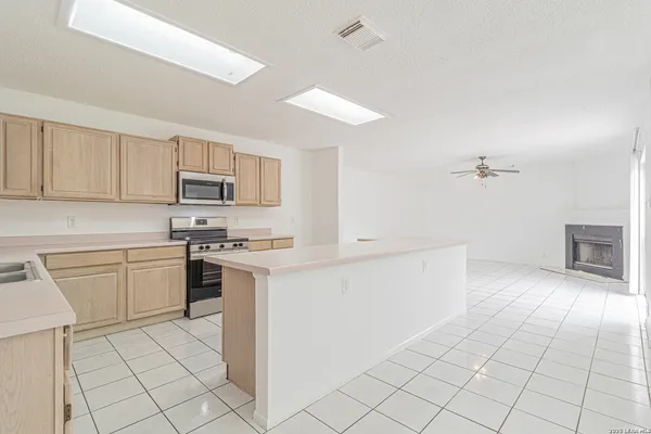 a kitchen with cabinets and appliances
