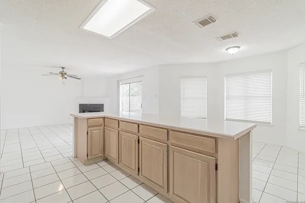 a room with white cabinets and window
