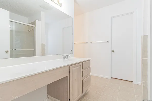 a bathroom with a tub sink and mirror