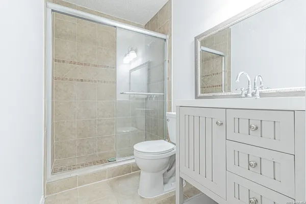 a bathroom with a toilet and a shower