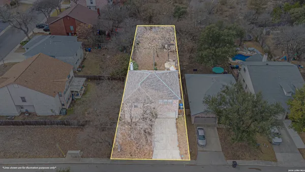 an aerial view of a house with a yard