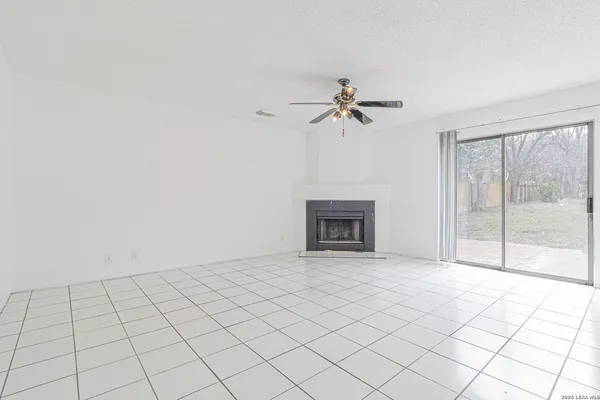 a view of an empty room with a fireplace