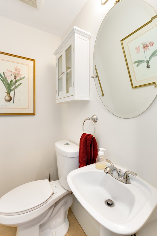 55 6th Street, Unit 55 Cambridge, MA 02141 - Photo 12 of 21 a bathroom with a toilet a sink and mirror