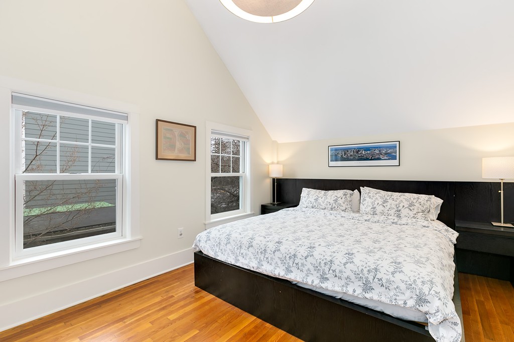 55 6th Street, Unit 55 Cambridge, MA 02141 - Photo 15 of 21 a bed sitting in a bedroom next to a window