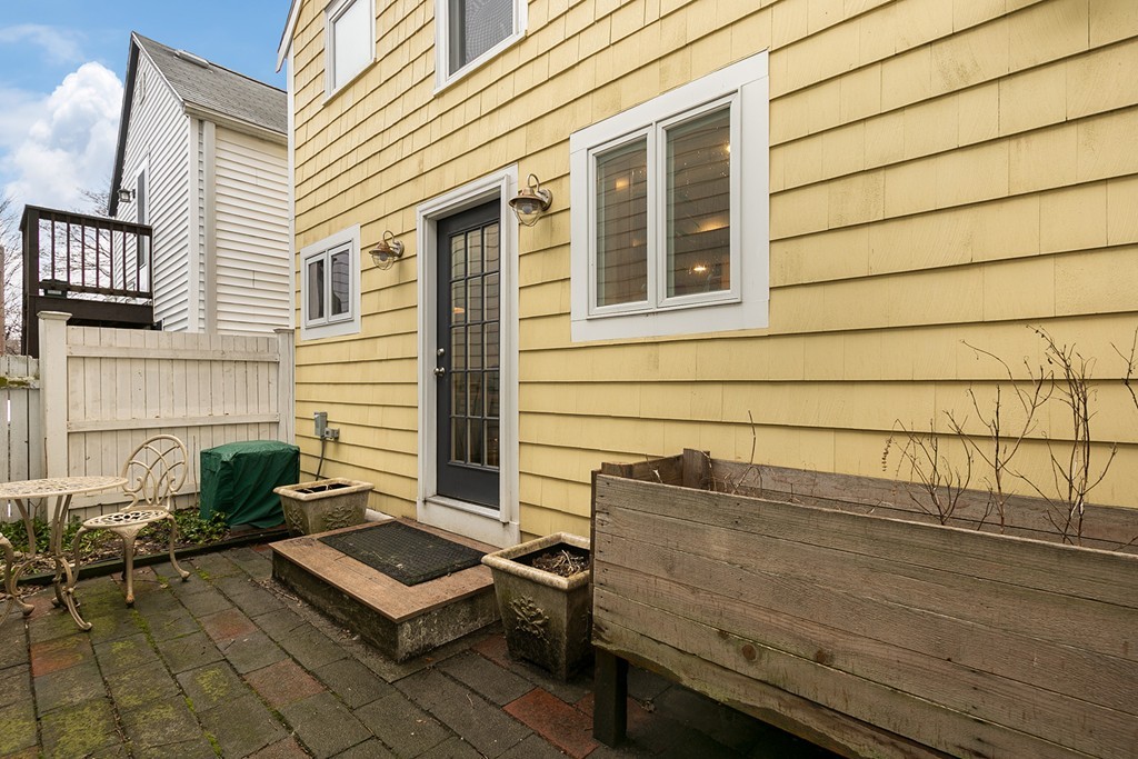 55 6th Street, Unit 55 Cambridge, MA 02141 - Photo 20 of 21 a view of a chair and table in the back yard of the house