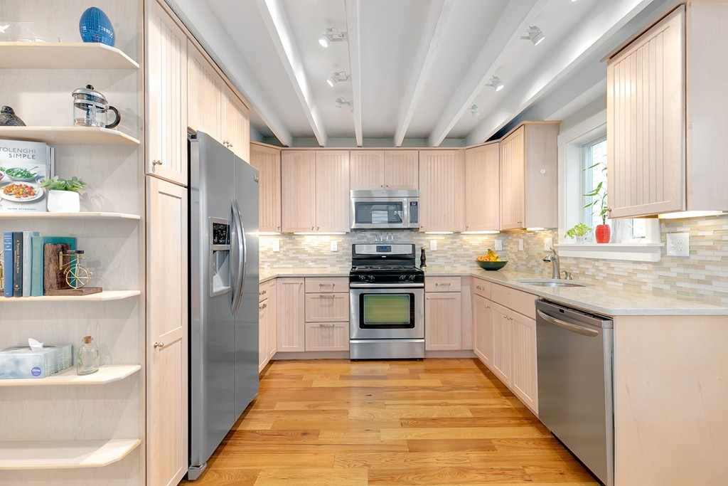 55 6th Street, Unit 55 Cambridge, MA 02141 - Photo 8 of 21 a kitchen with stainless steel appliances granite countertop a refrigerator and a sink