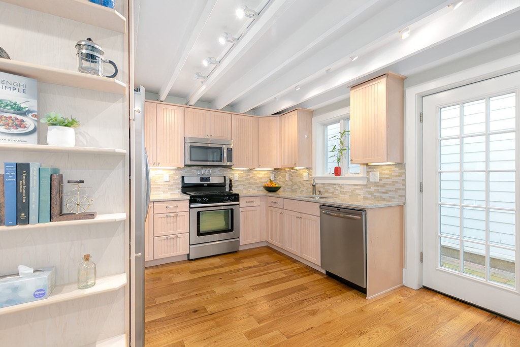 55 6th Street, Unit 55 Cambridge, MA 02141 - Photo 9 of 21 a kitchen with granite countertop a stove a sink and a refrigerator