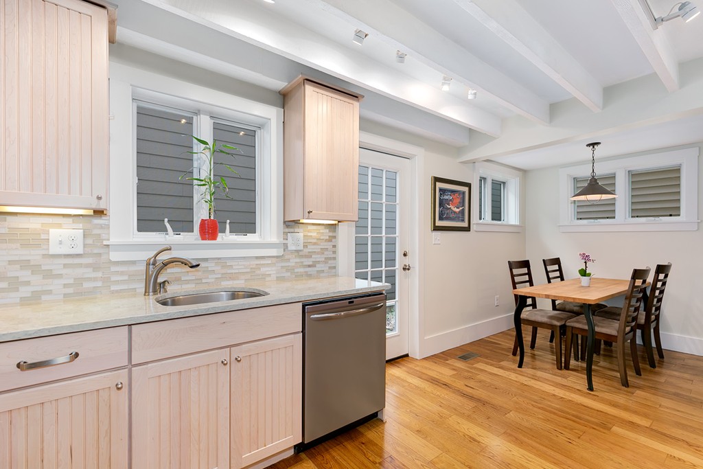 55 6th Street, Unit 55 Cambridge, MA 02141 - Photo 10 of 21 a kitchen with stainless steel appliances granite countertop wooden floor a dining table and chairs