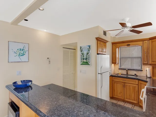 a kitchen with stainless steel appliances granite countertop a stove a refrigerator and a sink
