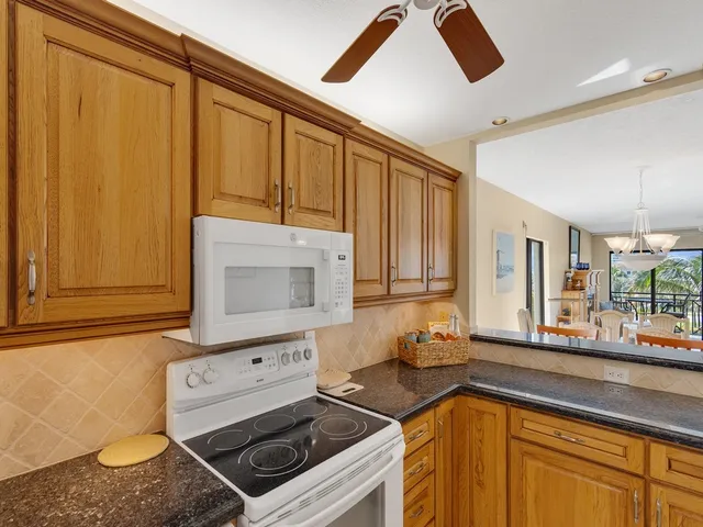 a kitchen with stainless steel appliances granite countertop a sink and cabinets