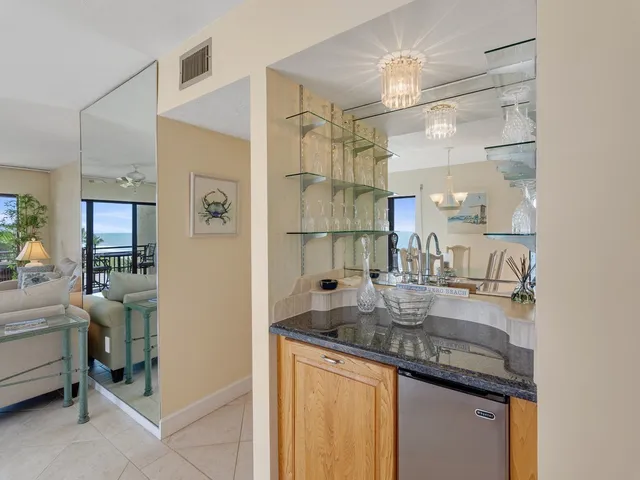 a kitchen with stainless steel appliances granite countertop a sink and refrigerator
