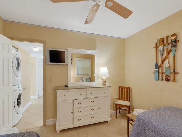 a spacious bedroom with a bed and a dresser in it