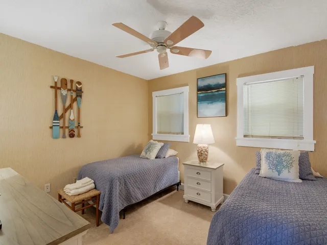 a bedroom with a bed and ceiling fan