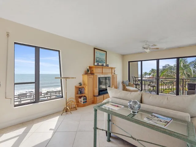 a living room with furniture and large windows