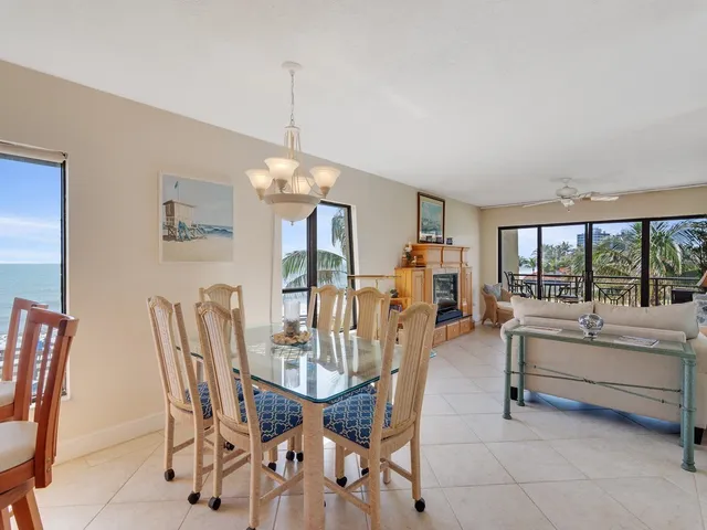 a view of a dining room with furniture large windows and wooden floor