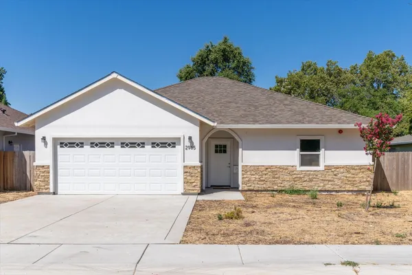 a front view of a house with garage