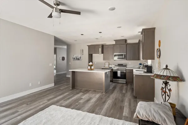a kitchen with a refrigerator and white cabinets