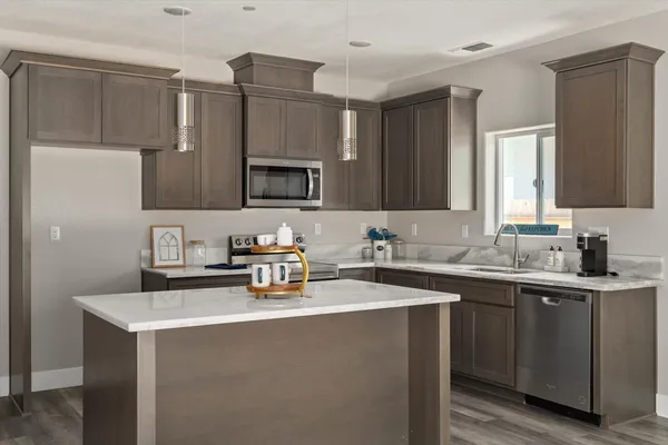 a kitchen with a sink a stove a microwave and cabinets