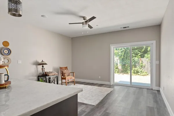 a view of a workspace with furniture and a window