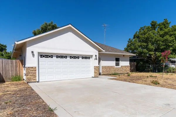 a view of a house with a yard and garage