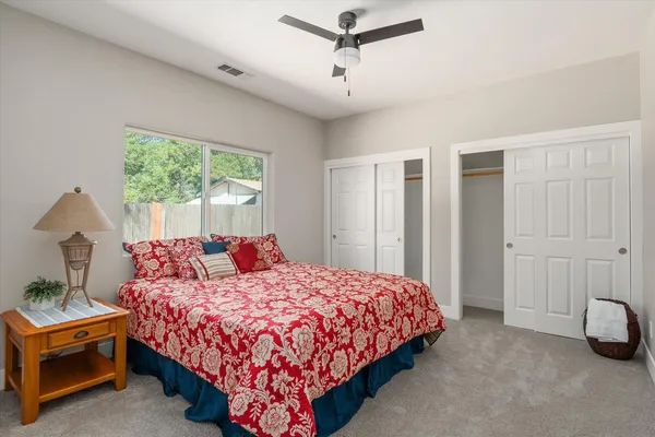 a bedroom with a bed and a window