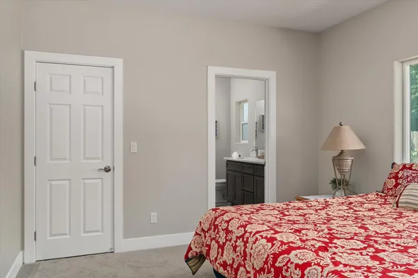 a bedroom with a bed and a lamp