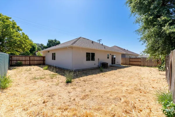 a backyard of a house with wooden fence