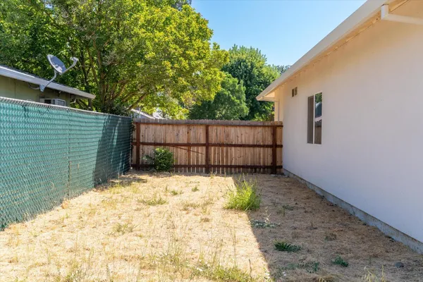 a backyard of a house with wooden fence