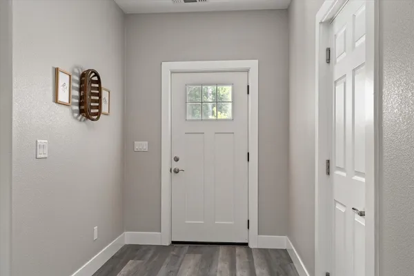 a view of an entryway with wooden floor