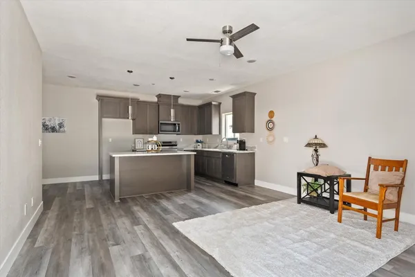a large white kitchen with a white wooden cabinets and stainless steel appliances