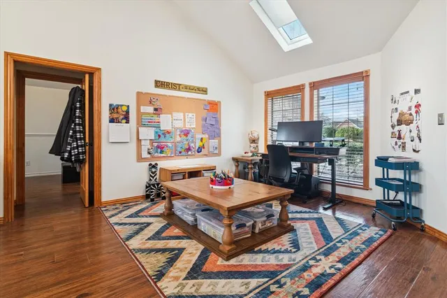 a living room with furniture a bookshelf and a window