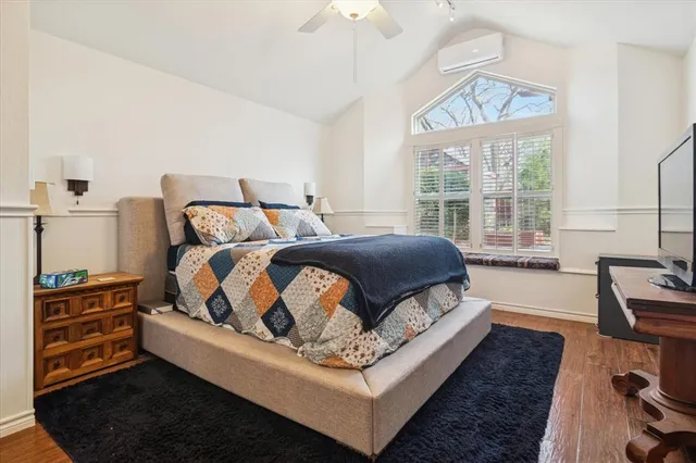 a bedroom with a bed and a dresser in it