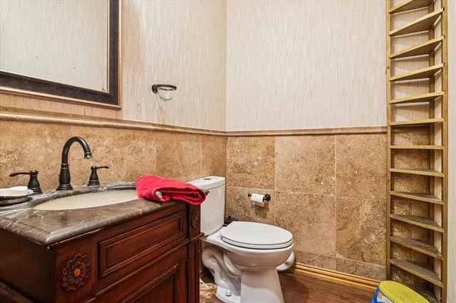 a bathroom with a sink a toilet and shower curtain