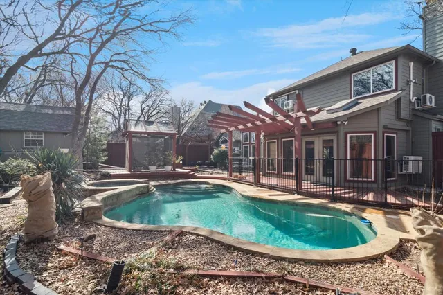 a view of a house with swimming pool and sitting area