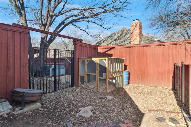 a backyard of a house with barbeque oven table and chairs