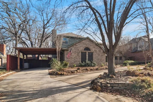 a front view of a house with a yard covered with snow