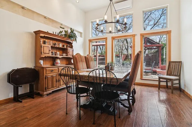 a view of a dining room with furniture a chandelier and wooden floor