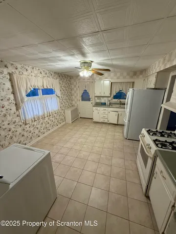 a kitchen with a sink a stove and refrigerator