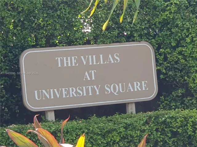 a sign broad in front of the red brick house