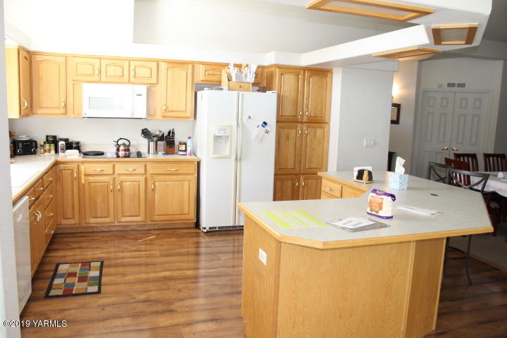 875 Division Road Zillah, WA 98953 - Photo 14 of 38 a kitchen with stainless steel appliances granite countertop a sink a refrigerator and a stove