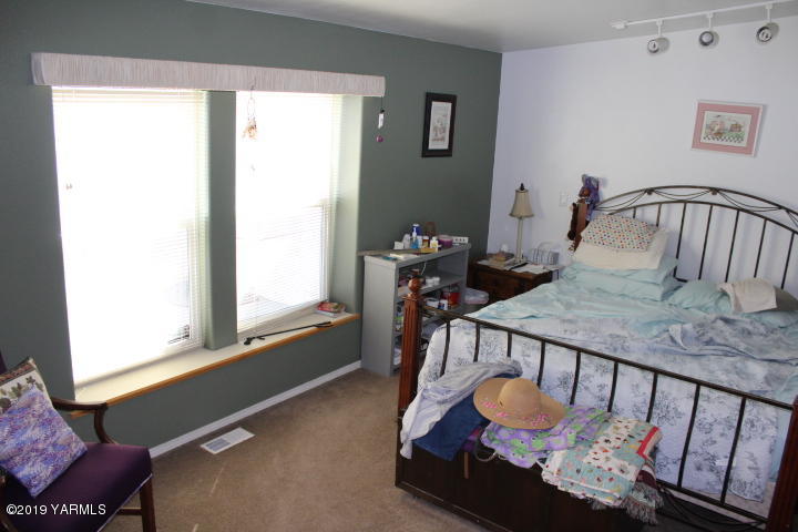875 Division Road Zillah, WA 98953 - Photo 22 of 38 a living room with furniture and a window