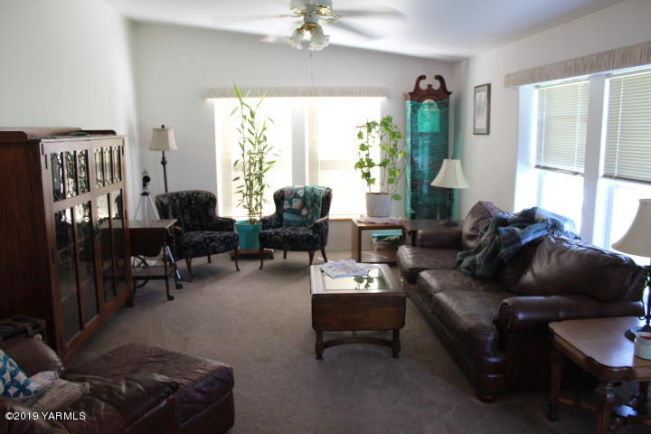 875 Division Road Zillah, WA 98953 - Photo 8 of 38 a living room with furniture and a large window